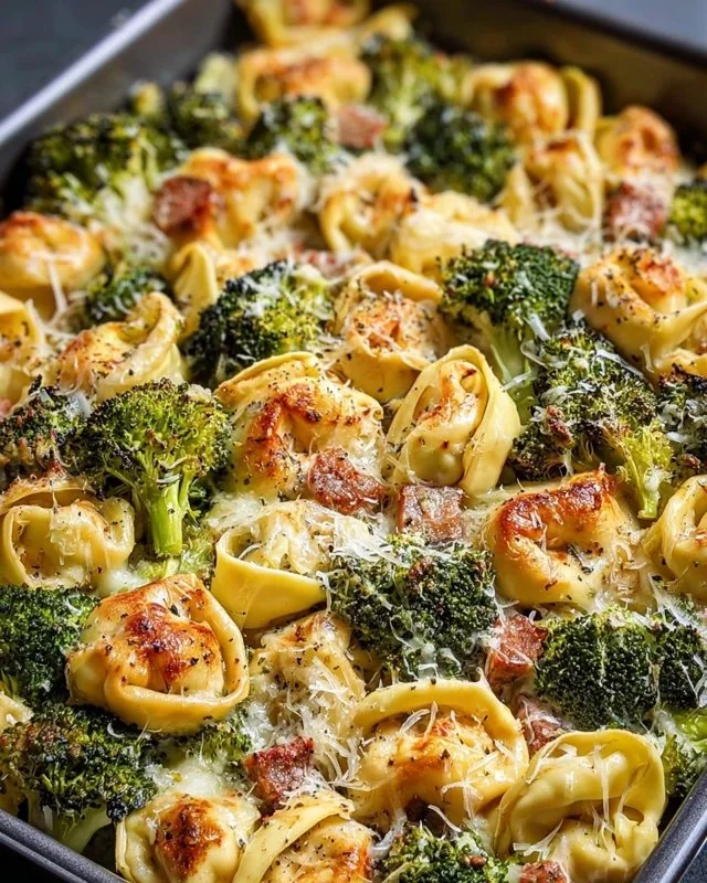 Sheet pan broccoli tortellini bake with fresh vegetables and melted cheese