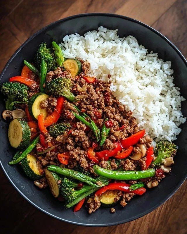 Spicy ground beef stir-fry bowl with garlic vegetables and rice