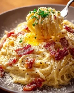 Delicious plate of authentic Carbonara with creamy sauce and pancetta.