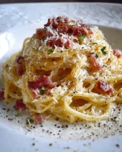 A delicious plate of authentic Pasta Carbonara garnished with parsley.