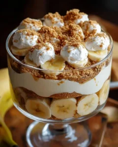 Biscoff Banana Pudding dessert in a glass with banana slices and Biscoff cookies on top