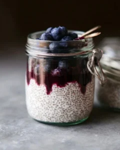 Blueberry coconut chia seed pudding served in a bowl topped with fresh blueberries.
