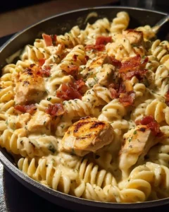 Delicious Chicken Bacon Ranch Pasta topped with crispy bacon and herbs