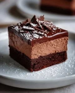 Decadent chocolate mousse brownies topped with creamy chocolate mousse