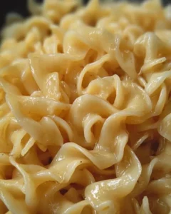 Creamy cafeteria noodles served in a bowl with garnish