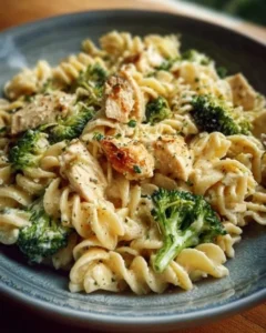Creamy rotisserie chicken broccoli pasta dish served in a bowl.