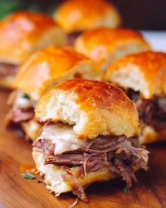 Delicious French Dip Sliders served with au jus for dipping