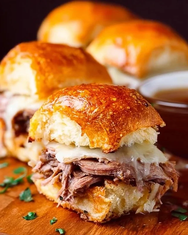 Delicious French Dip Sliders served with au jus for dipping