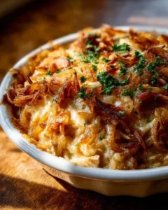 French onion chicken orzo casserole topped with melted cheese and herbs