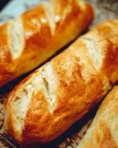 Freshly baked homemade French bread loaf on a wooden cutting board