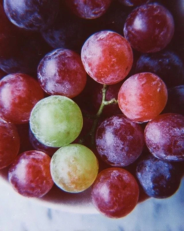 Bowl of vibrant Kool Aid Grapes snack with colorful grapes coated in powdered Kool Aid.