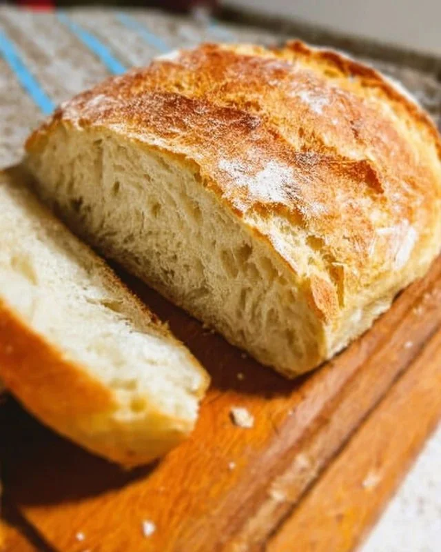 Freshly baked no knead bread loaf on a rustic wooden table