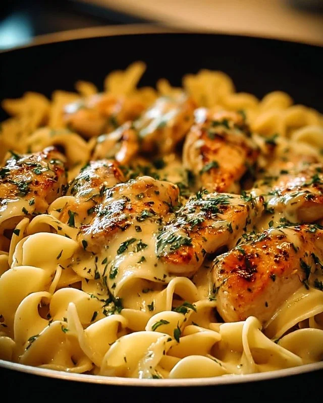 One-Pan Chicken served with creamy buttered noodles on a plate.