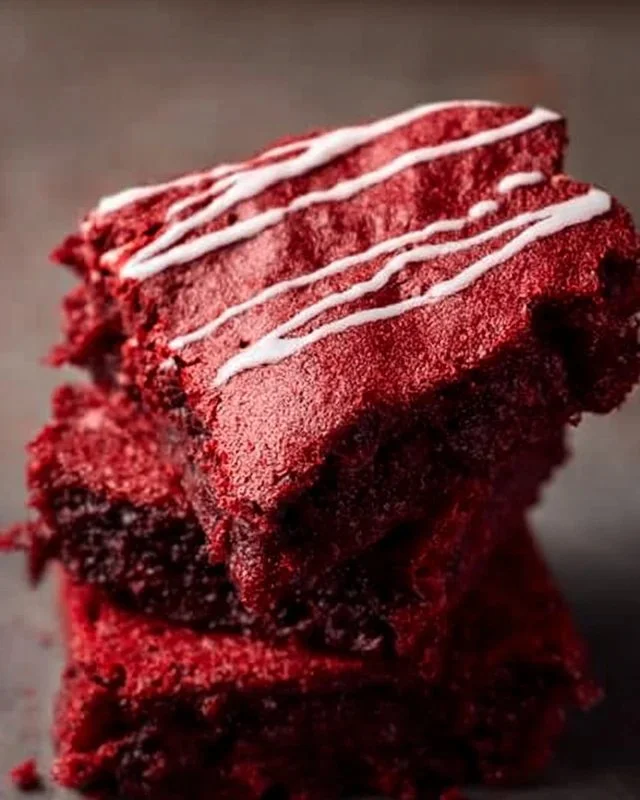 Decadent red velvet brownies topped with cream cheese frosting