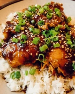 Slow Cooker Honey Garlic Chicken served with rice and vegetables on a plate
