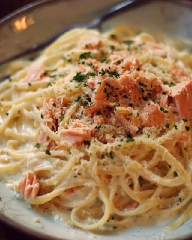Plate of delicious smoked salmon carbonara garnished with fresh herbs
