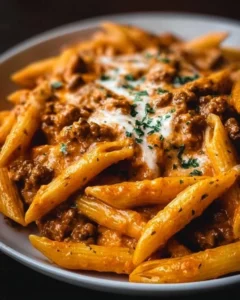 Creamy high protein beef pasta with fresh ingredients in a bowl