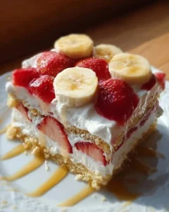 Half Strawberry Shortcake Half Banana Pudding Cake topped with fresh strawberries