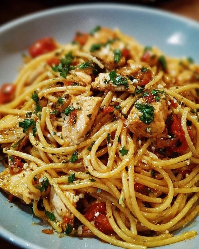 Delicious Monterey Chicken Spaghetti served on a plate with fresh herbs.